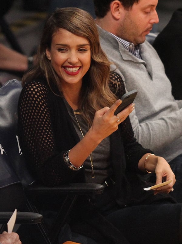 Jessica Alba's gray top was sleeveless, but she made sure to keep warm with a cardigan