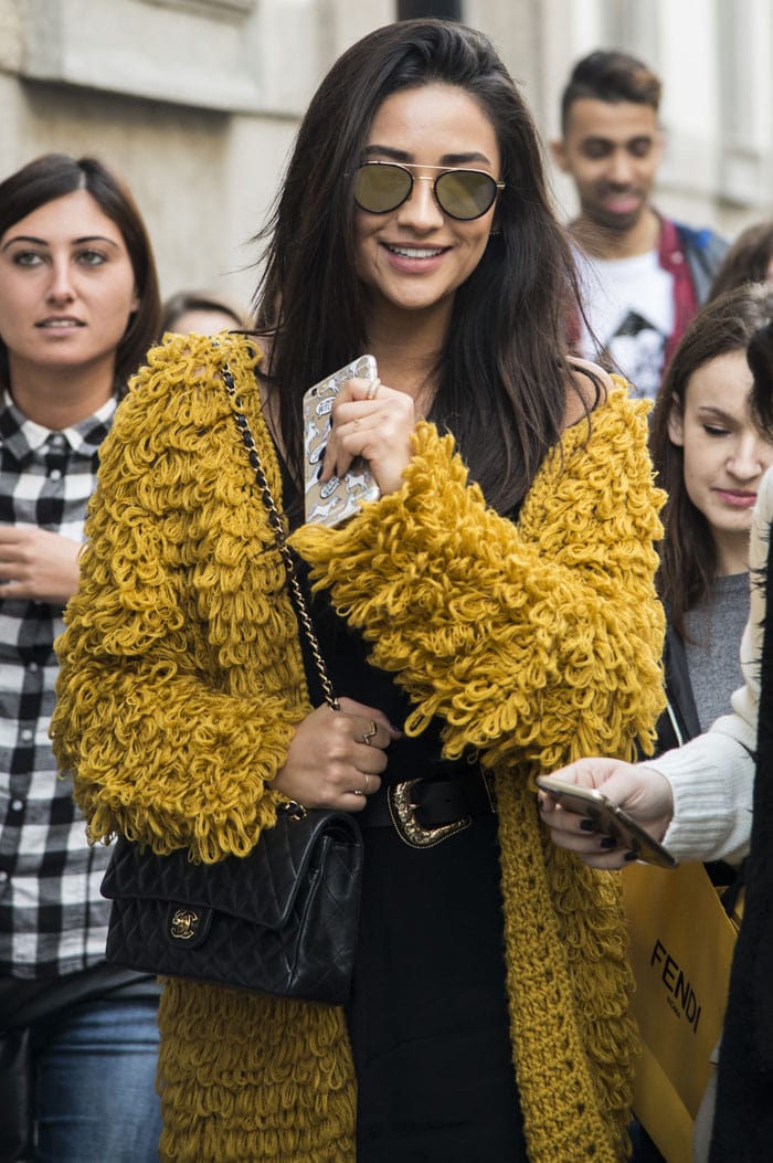 Shay Mitchell wears a yellow mustard knit cardigan on a shopping trip