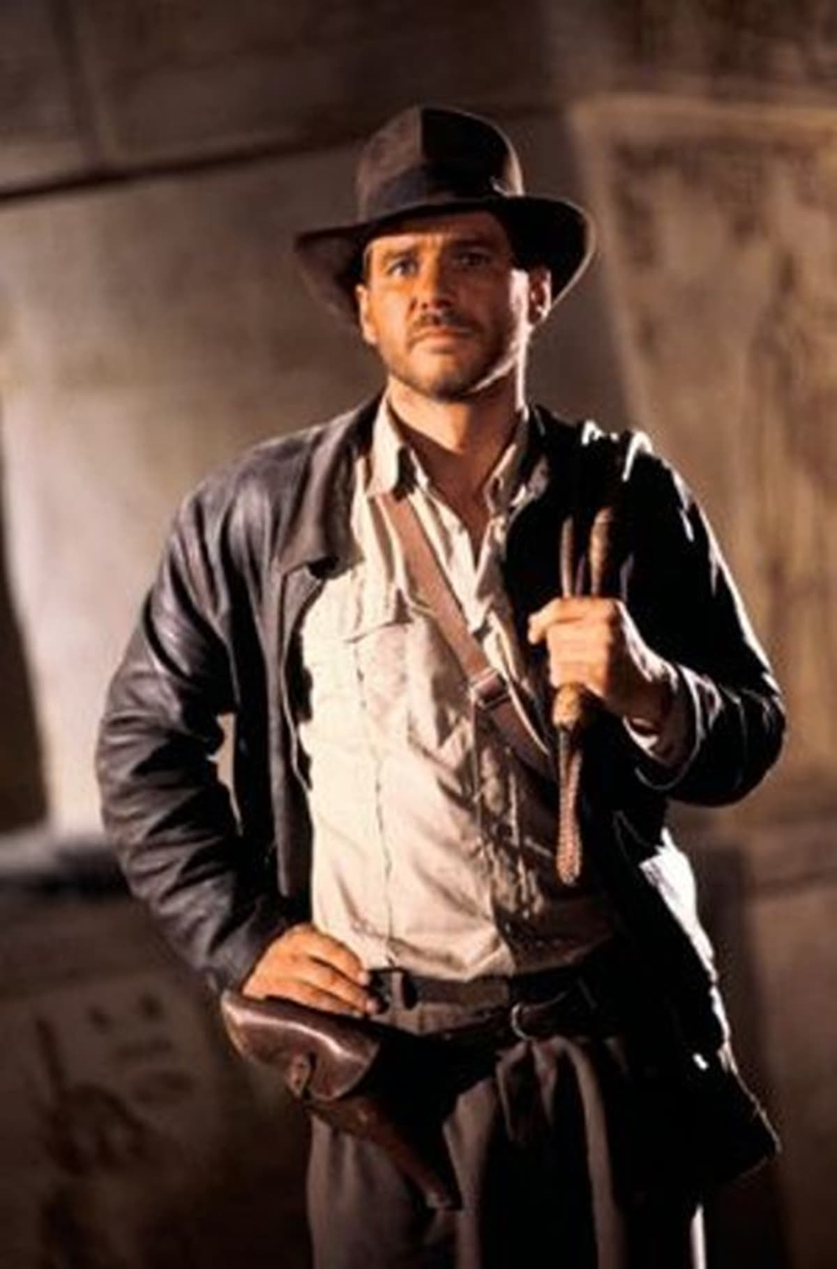 Harrison Ford wears a brown leather jacket as Indiana Jones in the 1981 American action-adventure film Raiders of the Lost Ark
